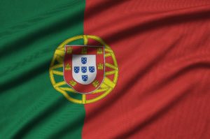 Portugal flag is depicted on a sports cloth fabric with many folds. Sport team waving banner